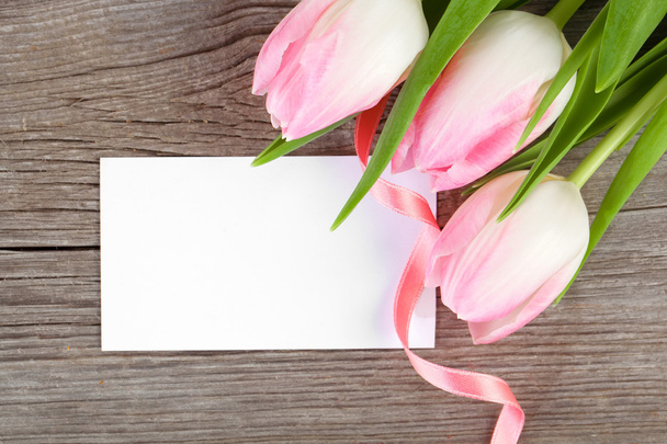 Pink tulips and blank card on wooden background - Foto, Imagem