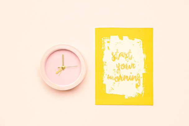 Card with text START YOUR MORNING and alarm clock on color background - Foto, Imagem