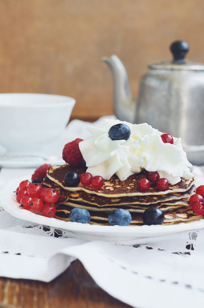 Coffee time with homemade pancakes with cream and fresh berries - Fotó, kép