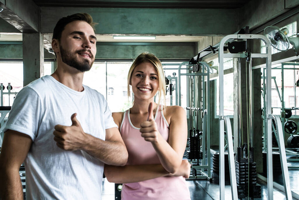 Smart sport man and woman working out in fitness gym healthy lifestyle - Photo, Image