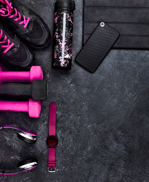 I think I have everything I need. High angle shot of a group of workout essentials lying on top of a dark background inside of a studio - Fotó, kép