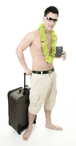 portrait of a man smiling leaning on a suitcase holding a passpo - Fotografie, Obrázek