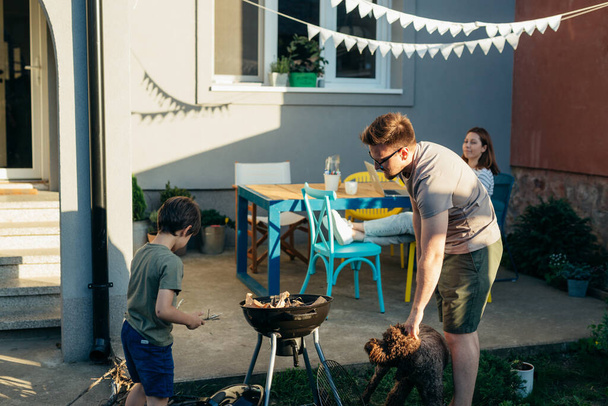 Family is having barbeque on weekends in the backyard - Foto, Imagem