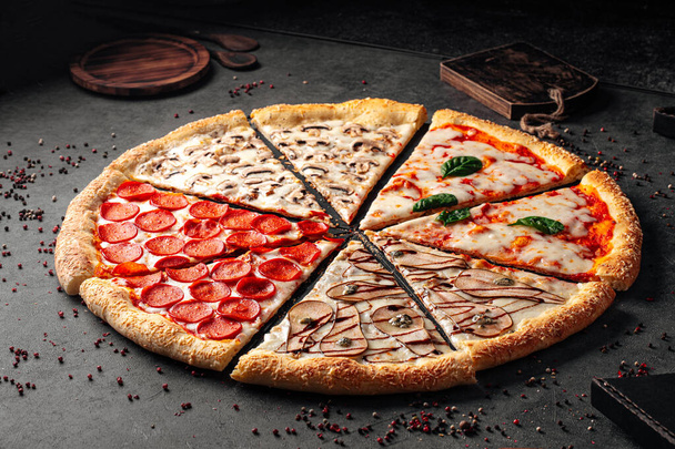 Vue latérale sur une grande pizza assortie avec une variété de garnitures - Photo, image