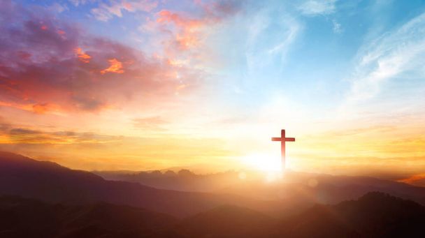 The crucifix symbol of Jesus on the mountain sunset sky background - Photo, Image