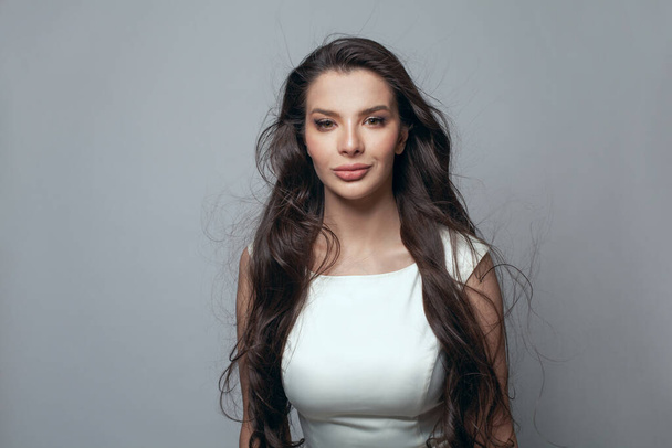 Portrait of perfect woman fashion model with long black hair on gray background - Zdjęcie, obraz