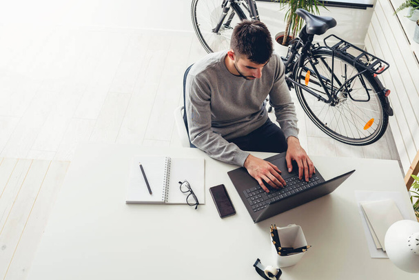 view of businessman using laptop,typing in office - Zdjęcie, obraz