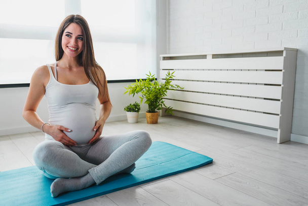 portrait of beautiful pregnant woman at gym  - Photo, Image