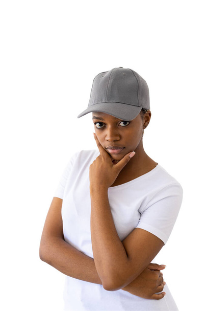 African american woman wearing white t-shirt and grey cap with copy space on white background. Clothes, fashion, style and design. - Foto, immagini