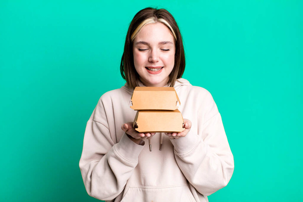 young pretty woman with burger boxes in the hands  - Fotó, kép