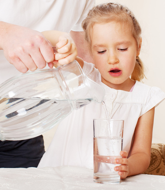 Child with glass pitcher water - Фото, зображення