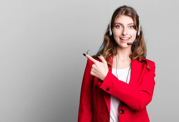 caucasian pretty woman looking excited and surprised pointing to the side. telemarketer agent concept - Foto, Bild