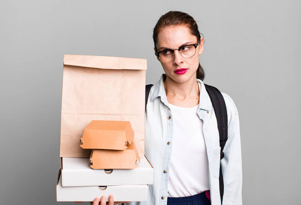 pretty hispanic woman feeling sad, upset or angry and looking to the side. delivery fast food take away concept - Fotó, kép