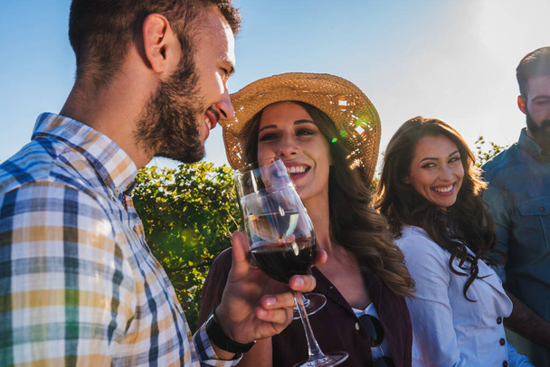friends drinking wine at vineyard - Foto, imagen
