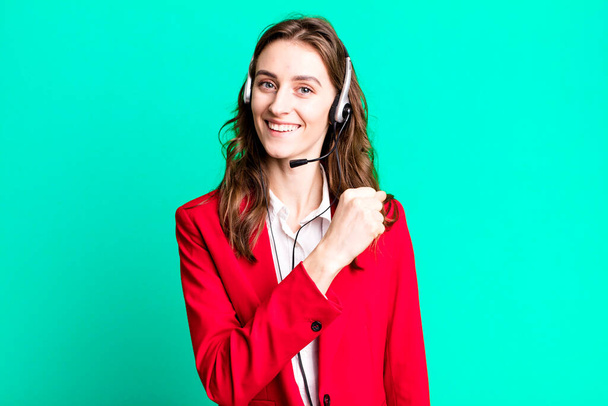 young pretty woman feeling happy and facing a challenge or celebrating. telemarketer concept - Photo, image