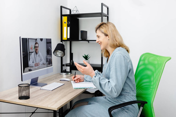 Caucasian doctor video conference call online live talk follow up remotely in medical result with woman sitting at chair at home. Online health care digital service concept - Foto, Imagem