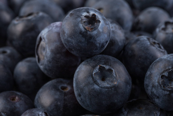 Group of fresh juisy blueberries on stone plate background - Fotografie, Obrázek