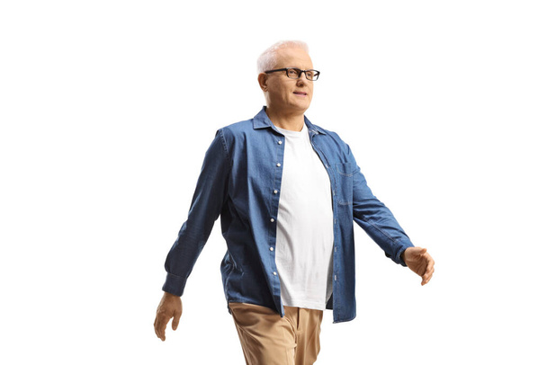 Mature man with glasses walking isolated on white background - Photo, image