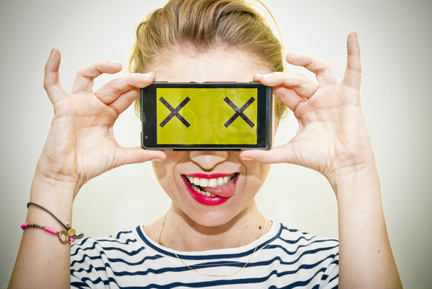 Woman with smartphone and crazy eyes - Foto, Imagen