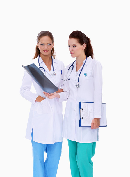 Two woman nurse watching X Ray image, standing in hospital - Fotó, kép