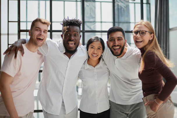 Portrait of successful creative business team looking at camera and smiling. Diverse business people standing together at startup. - Foto, imagen