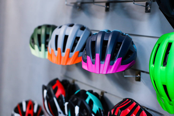  Focus on helmet. Bicycle helmets on the stand - Foto, Bild
