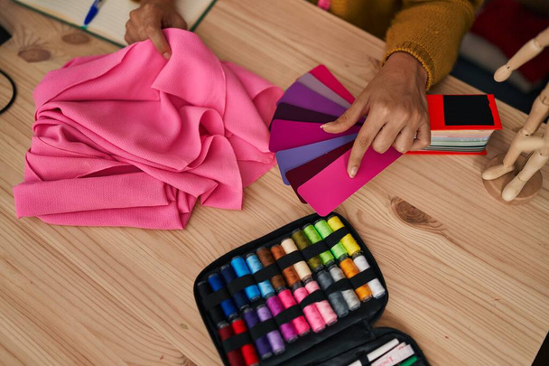 Young blonde woman dressmaker choosing cloth color at designer studio - Fotoğraf, Görsel