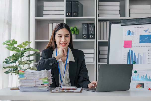 Business woman using calculator for do math finance on wooden desk in office and business working background, tax, accounting, statistics and analytic research concept.... - Photo, Image