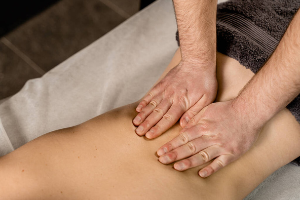 Classic massage close-up. Therapeutic massage with manipulating body to promote relaxation and reduce stress. Massage therapist use techniques such as friction, stretching, and tapping - Фото, зображення