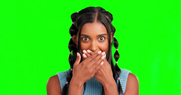 Woman, hands cover mouth and green screen studio with surprise, wow face and mind blown for mock up. Young indian student, amazed girl and gossip in mockup portrait for secret story by background. - Footage, Video