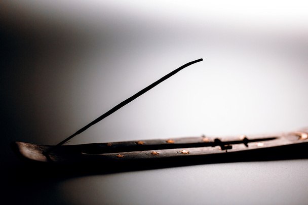 Incense stick on a wooden support on a white background - Photo, Image