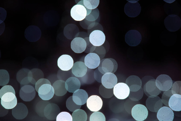 background blurred abstraction of colored lanterns and decorations. bokeh texture of street colored lights - Foto, Imagen