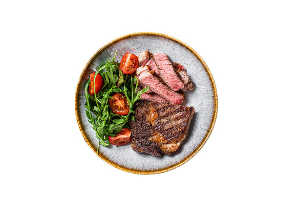 BBQ Grilled rib eye steak, fried rib-eye beef meat on a plate with green salad. Isolated on white background - Photo, Image