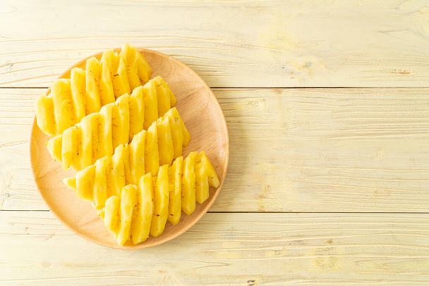 fresh pineapple sliced on wooden plate - Photo, Image