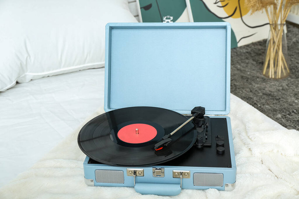 Grabador con disco de vinilo en manta en el dormitorio - Foto, Imagen