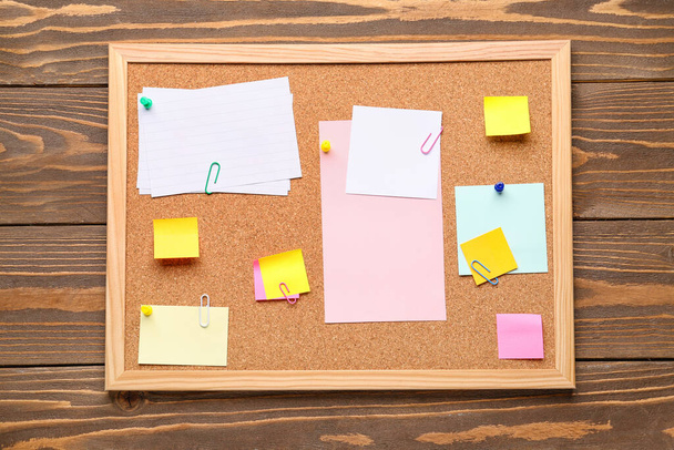 Board with different sticky notes on wooden background - Fotografie, Obrázek