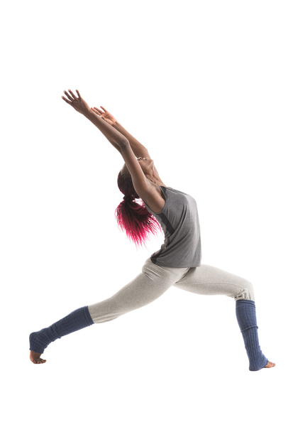 Woman practicing Warrior yoga pose - Фото, изображение