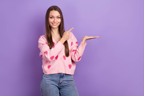 Photo of young promoter gorgeous woman hold arm cheap product direct finger useful proposition brand slogan isolated on violet color background. - Фото, зображення