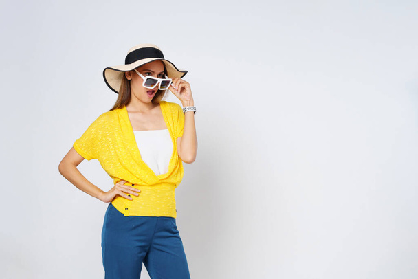 Happy mix race woman in sunglasses wearing, colorful clothes and sun hat, isolated over white background.Lifestyle summer concept. - Foto, Imagen