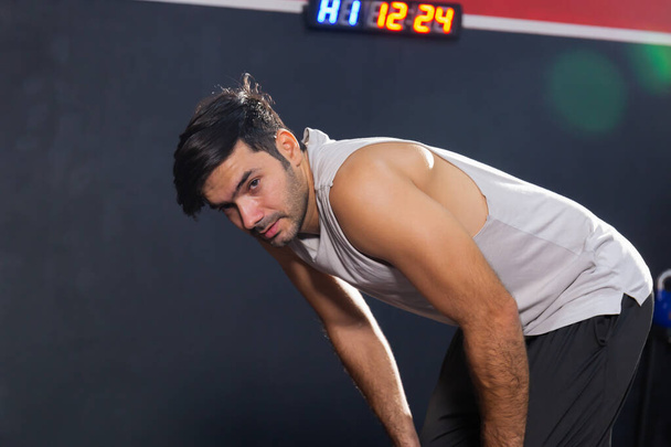 Tired man in fitness gym, Sport and fitness concept - 写真・画像