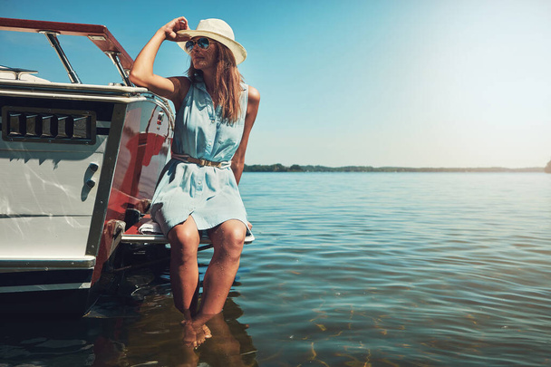 Surrounded by nothing but the sea. an attractive young woman spending the day on her private yacht - Foto, Imagem