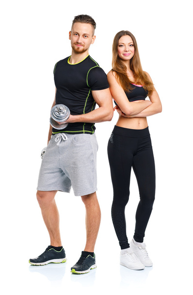 Sport couple - man and woman with dumbbells on the white - Photo, Image