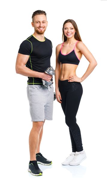 Sport couple - man and woman with dumbbells on the white - Φωτογραφία, εικόνα