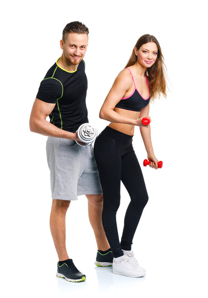 Sport couple - man and woman with dumbbells on the white - Photo, Image