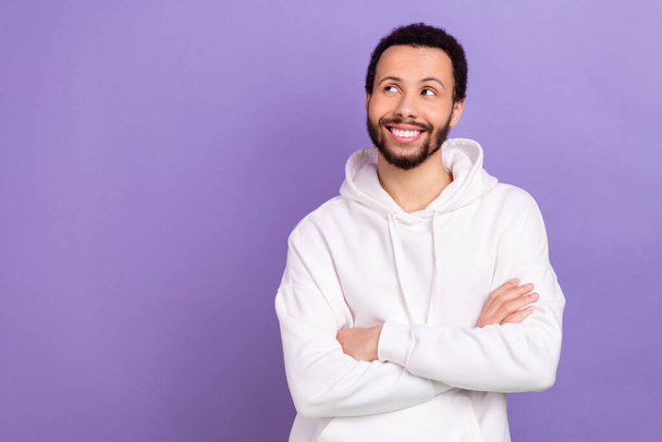 Portrait of positive minded man folded hands toothy smile look empty space isolated on purple color background. - Foto, afbeelding