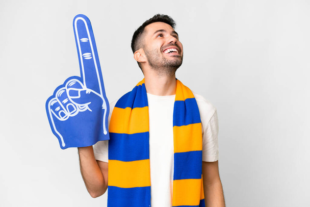 Young caucasian sports fan man over isolated white background laughing - Zdjęcie, obraz