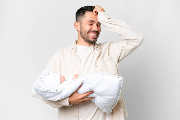 Молодий кавказький батько зі своєю новонародженою дитиною на ізольованому тлі щось зрозумів і мав намір вирішити
 - Фото, зображення