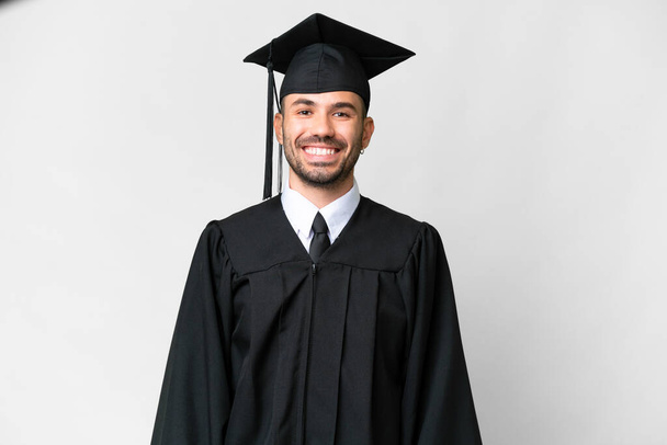 Young university graduate man over isolated white background laughing - Foto, afbeelding