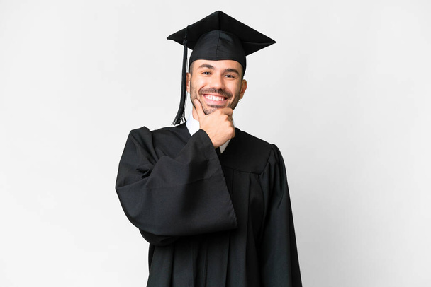 Young university graduate man over isolated white background smiling - Фото, зображення