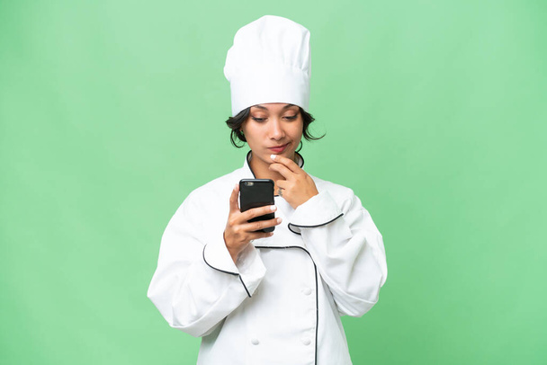 Young chef Argentinian woman over isolated background thinking and sending a message - Фото, зображення